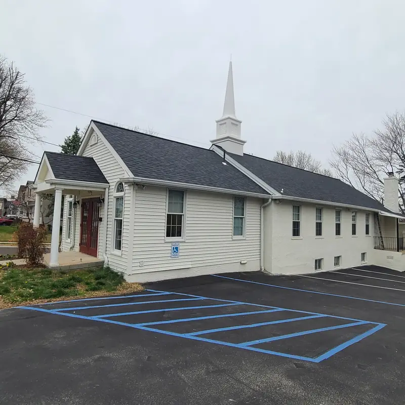 Ardsley Bible Chapel with its red door and white steeple, reroofed by Aronson Roofing and Siding